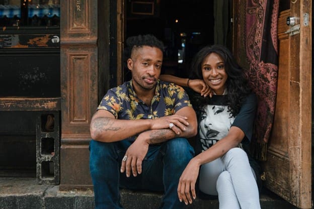 https://www.pexels.com/photo/man-and-woman-sitting-on-steps-in-front-of-bar-10375877/